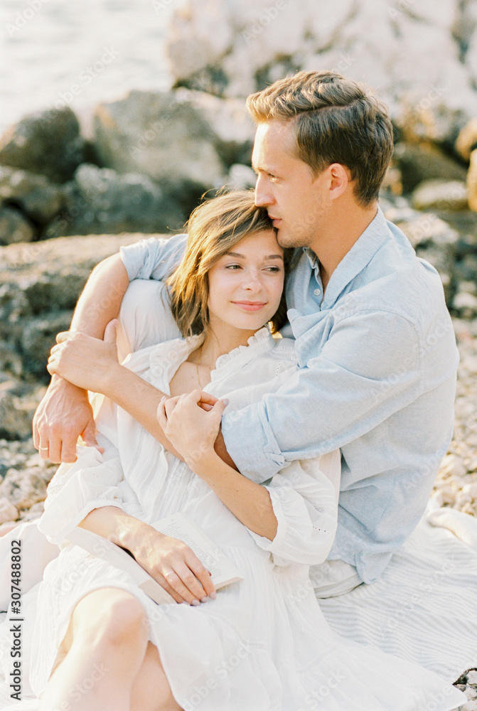 young couple hugging on the seashore young couple hugging on the seashore