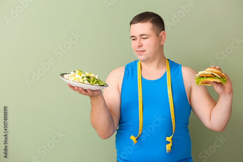 Overweight man with measuri...