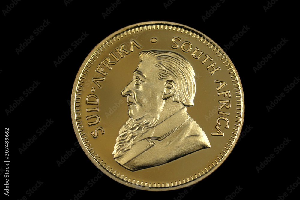A close up, shot in macro image of a South African Krugerrand isolated on a solid black background A close up, shot in macro image of a South African Krugerrand isolated on a solid black background
