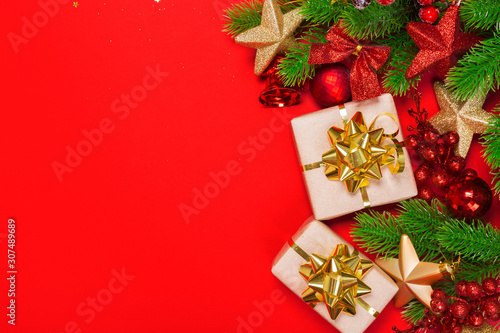 Christmas red background with herringbone and decor. Gold and red jewelry. Top view with space for copy.