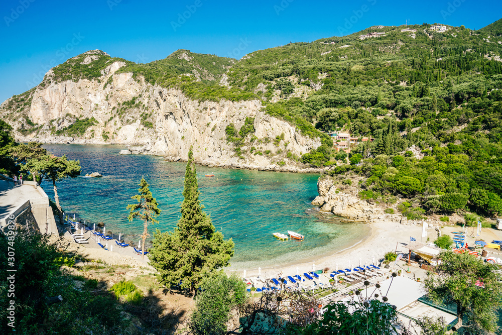 Cozy beach Agios Petros surrounded by mountains covered by rich greenery.
