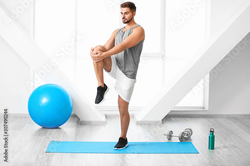 Sporty young man training in gym