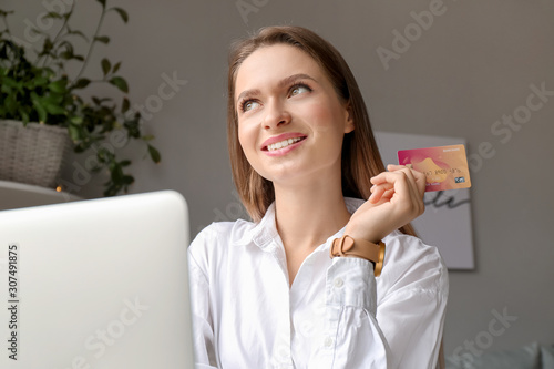 Smiling young woman holding...
