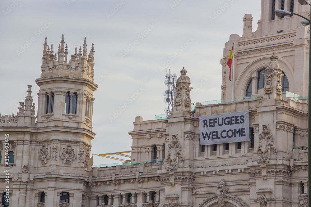 Welcome Refugees on facade of building in Madrid spain