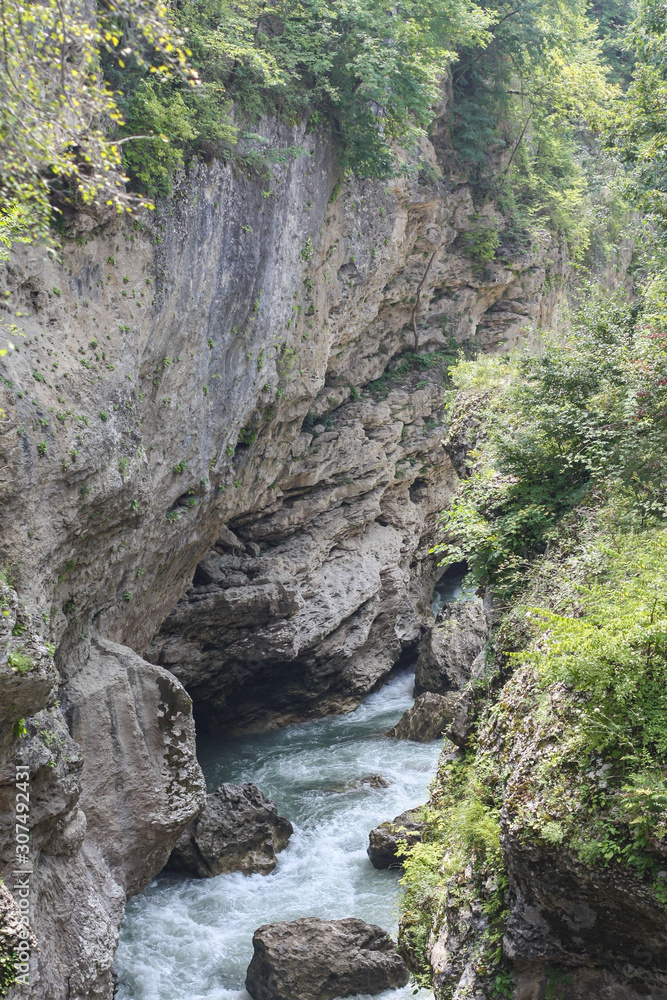 Obraz premium Pure and beautiful natural scenery of river White, Caucasus, Russia. The road goes up the mountain river. Canyon gorge, rocks, river and summer forest. 