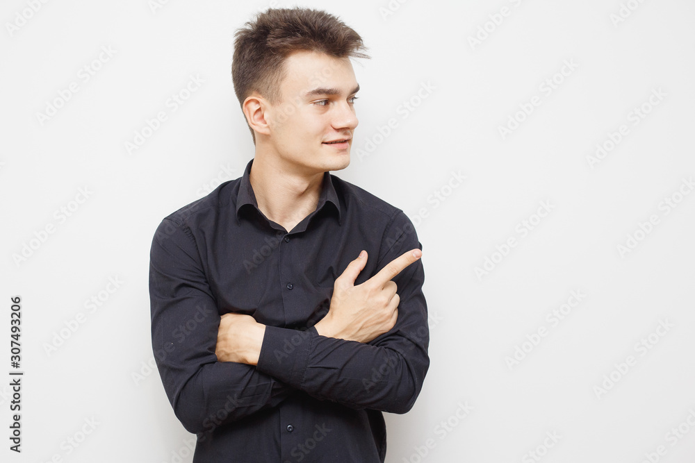 Man having and idea. Young hipster man looking in the camera and pointing up with a nice face. Happy young guy pointing up. With copy-space. Man having and idea. Young hipster man looking in the camera and pointing up with a nice face. Happy young guy pointing up. With copy-space.