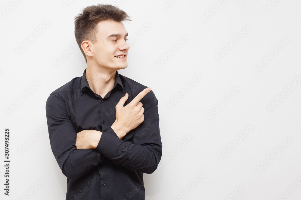 Man having and idea. Young hipster man looking in the camera and pointing up with a nice face. Happy young guy pointing up. With copy-space. Man having and idea. Young hipster man looking in the camera and pointing up with a nice face. Happy young guy pointing up. With copy-space.