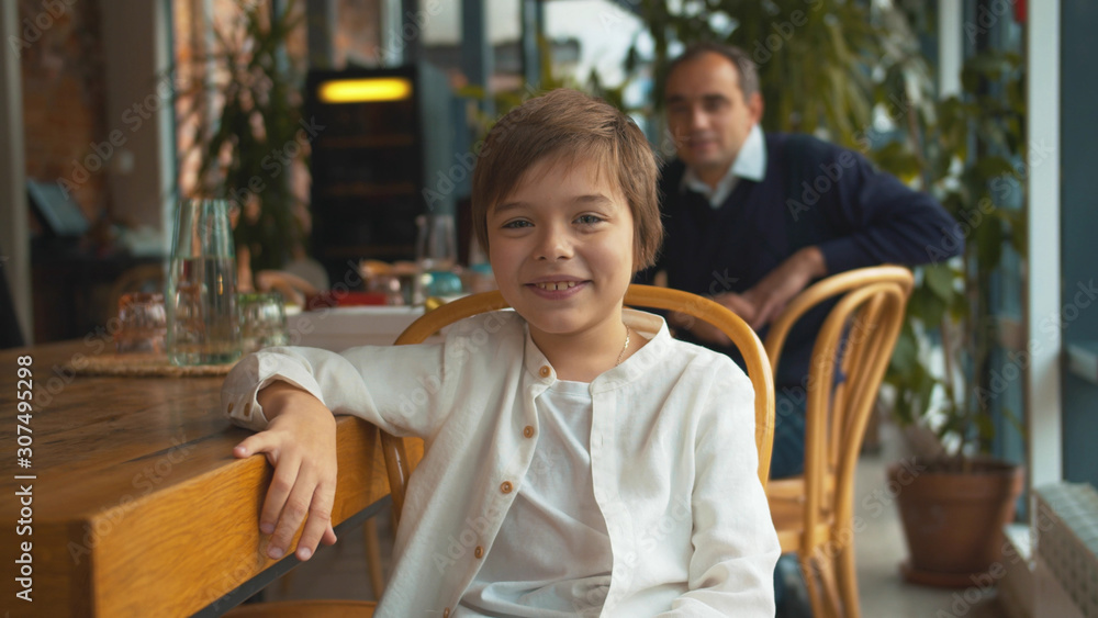 Little boy sit on chair, look at camera and smile Little boy sit on chair, look at camera and smile