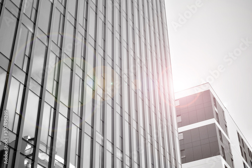 Wallpaper Mural Modern office building wall made of steel and glass with blue sky. Glass surface with sunlight. Black and white. Torontodigital.ca