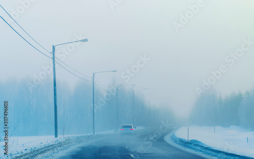Car on Winter road with snow in Finland. Auto and Cold landscape of Lapland. Automobile on Europe forest. Finnish City highway ride. Roadway and route snowy street trip. Driving