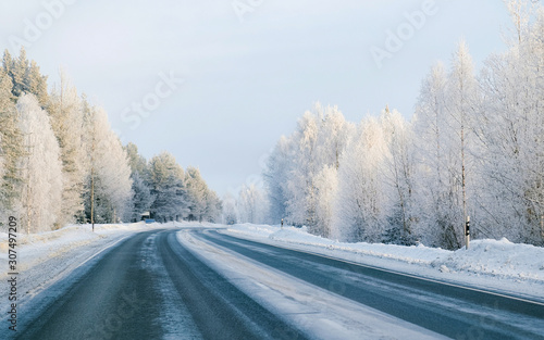 Winter road with snow in Finland. Cold landscape of Lapland. Europe forest. Finnish City highway ride. Roadway and route snowy street trip. Driving