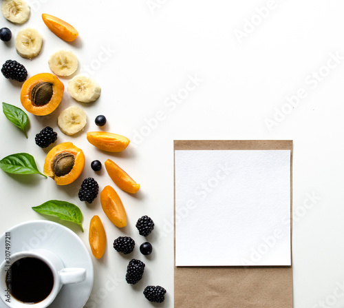 Creative layout of fresh summer fruits and coffee on a white background with space for text. 