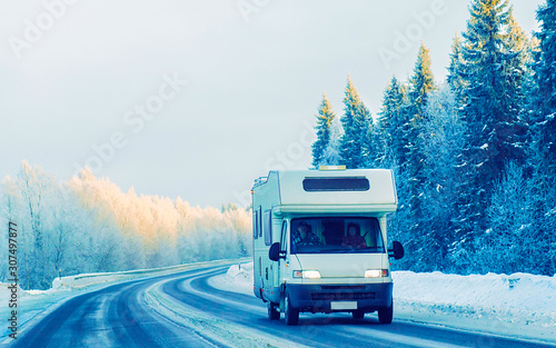 Mini Van on Winter road with snow in Finland. Car and cold landscape of Lapland. Europe forest. Finnish City highway ride. Roadway and route snowy street trip. Driving