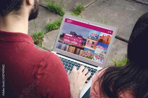 Photography Man with laptop booking a hotel on website