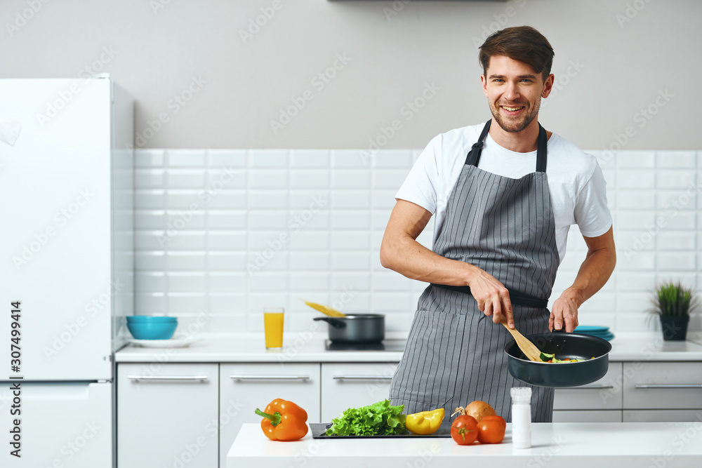 man cooking in kitchen man cooking in kitchen