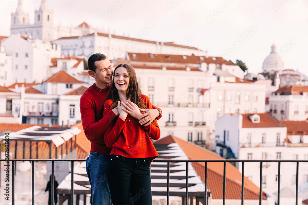 Fototapeta premium Lisbon, Portugal - 20 January, 2019. couple in stylish red sweat