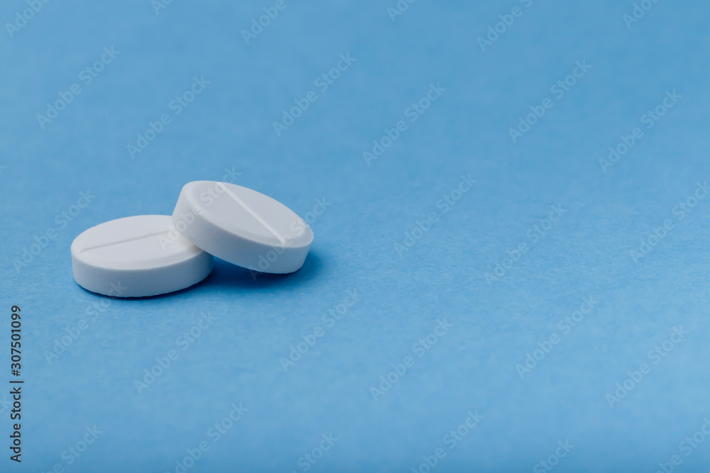 Two pills on a blue background, medicine, - obrazy, fototapety, plakaty 