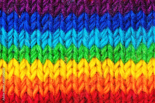 Background with bright sweater pattern in rainbow colors. © Olena Bloshchynska
