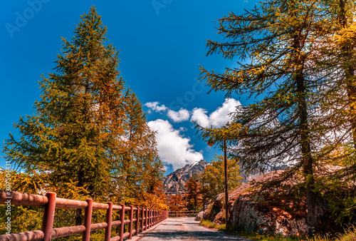 Autumn road view of Gran Paradiso Italian alps mountains in Graian Alps in Piedmont, Italy with snow capped peaks.