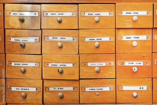 Library of account cards. File cabinet for library cards. Vintage cabinet. Cells for storing information, database. Library boxes. © Антон Брехов