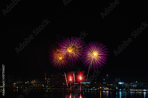 Beautiful fireworks against the background as over city scape view of night city in Thailand. © Anek