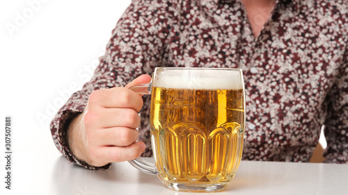 Close up of beer holding by male hand.