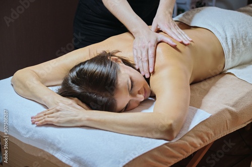 Professional back massage procedure, adult woman receiving treatment