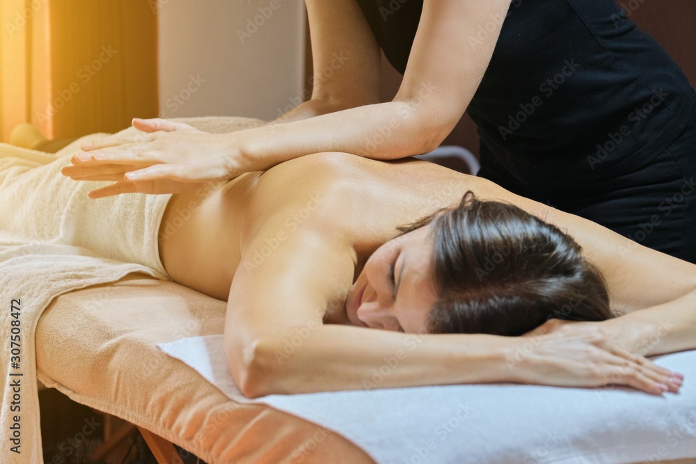 Obraz premium Professional back massage procedure, adult woman receiving treatment