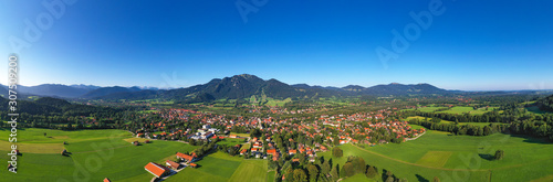 Drone shot of Lenggries with Brauneck against clear blue sky, Bavaria, Germany © Westend61