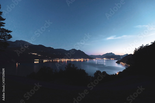 Switzerland, Gersau, Schwyz, Illuminated houses along coastline of Lake Lucerne at dusk