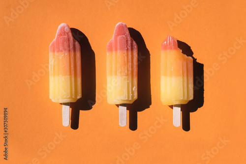 Directly above shot of sorbets arranged on orange background photo