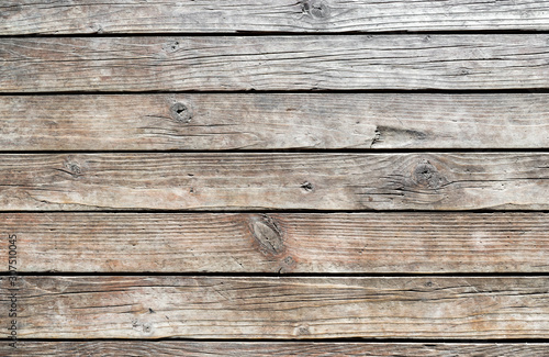 Horizontal wooden texture wall of rural house. Old dirty panels background