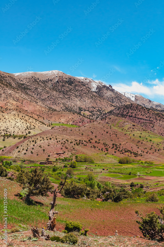 View of adobe village in the high snow-capped mountains in the Aït Bouguemez valley in Morocco