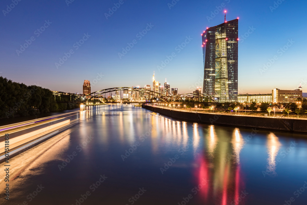 River in illuminated city against blue sky at night in Frankfurt, Germany River in illuminated city against blue sky at night in Frankfurt, Germany