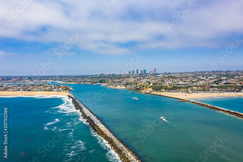 The Wedge separated by a seawall in Newport Beach