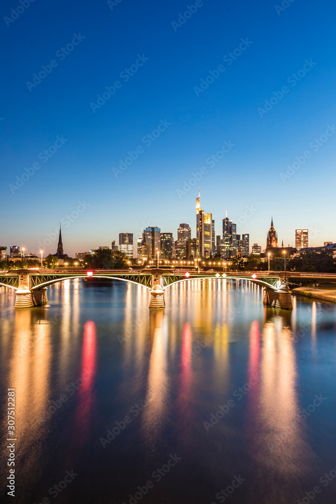 Illuminated Ignatz Bubis Bridge over River Main against blue sky during sunset, Frankfurt, Germany Illuminated Ignatz Bubis Bridge over River Main against blue sky during sunset, Frankfurt, Germany
