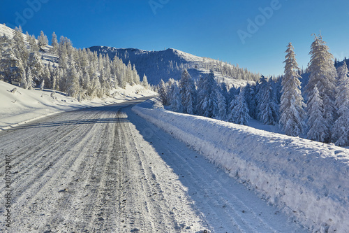 Winter. The mountains. Road, descent from the pass. Trees in the snow photo