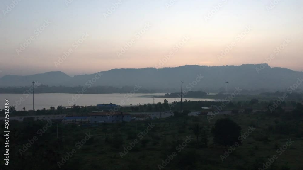 Beautiful overview of lake in India at sunset from out of a train during smooth ride Beautiful overview of lake in India at sunset from out of a train during smooth ride