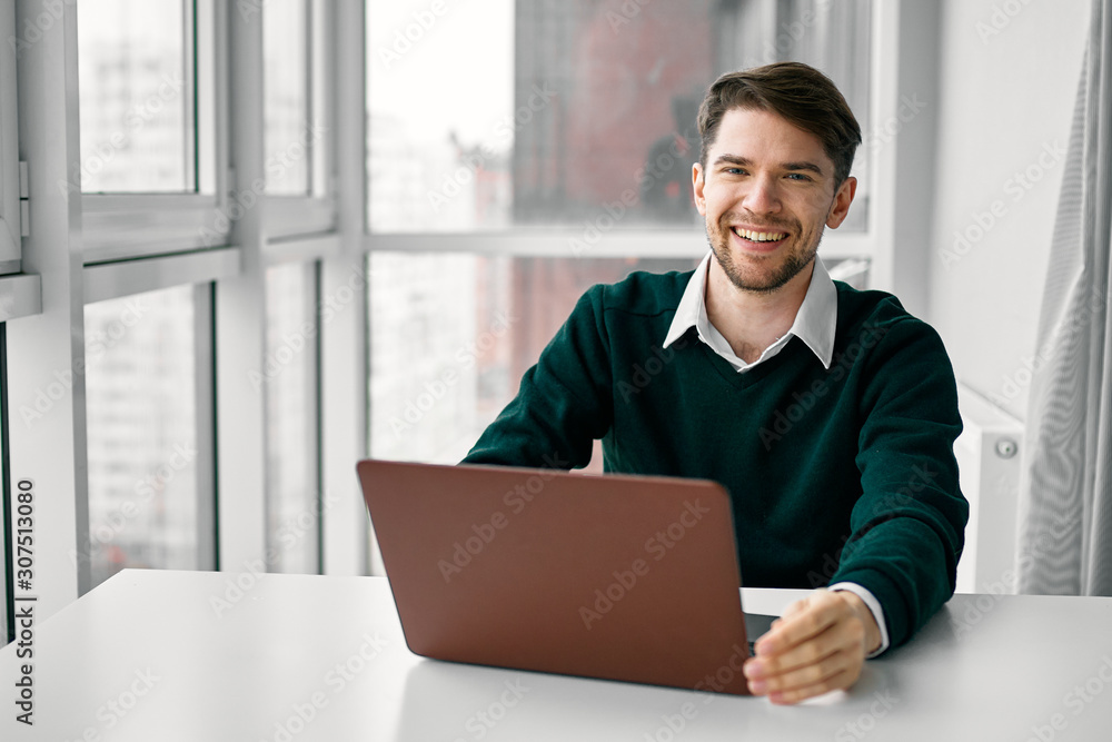 young man working on his laptop at home young man working on his laptop at home