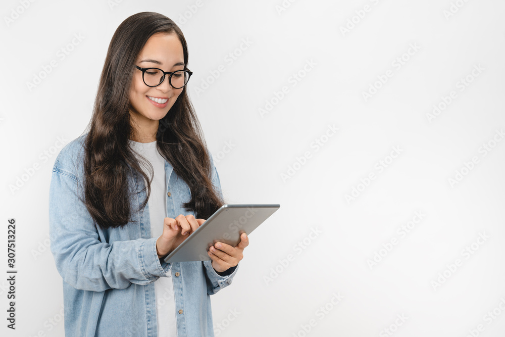 Smiling young woman using tablet computer isolated on white background Smiling young woman using tablet computer isolated on white background
