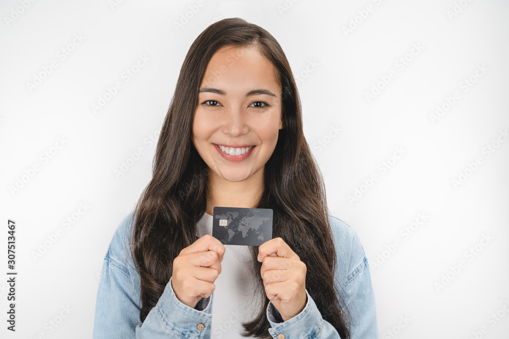 Close up portrait of young girl showing credit card isolated over white background Close up portrait of young girl showing credit card isolated over white background