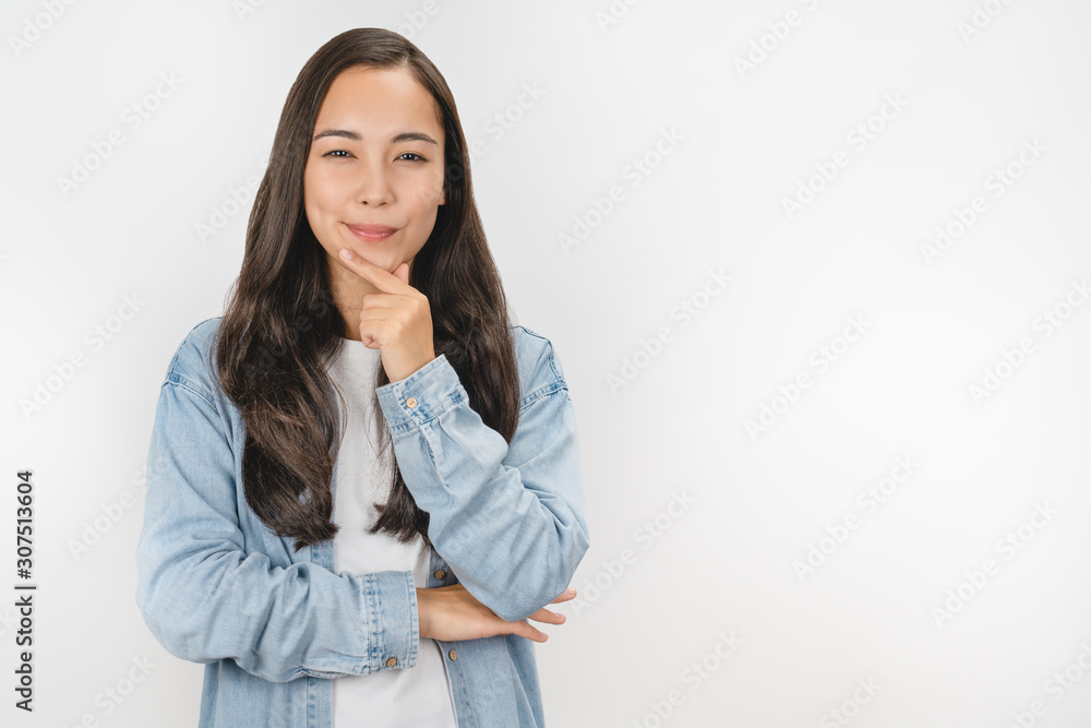 Image of thinking asian young lady with look in camera standing isolated over white background Image of thinking asian young lady with look in camera standing isolated over white background