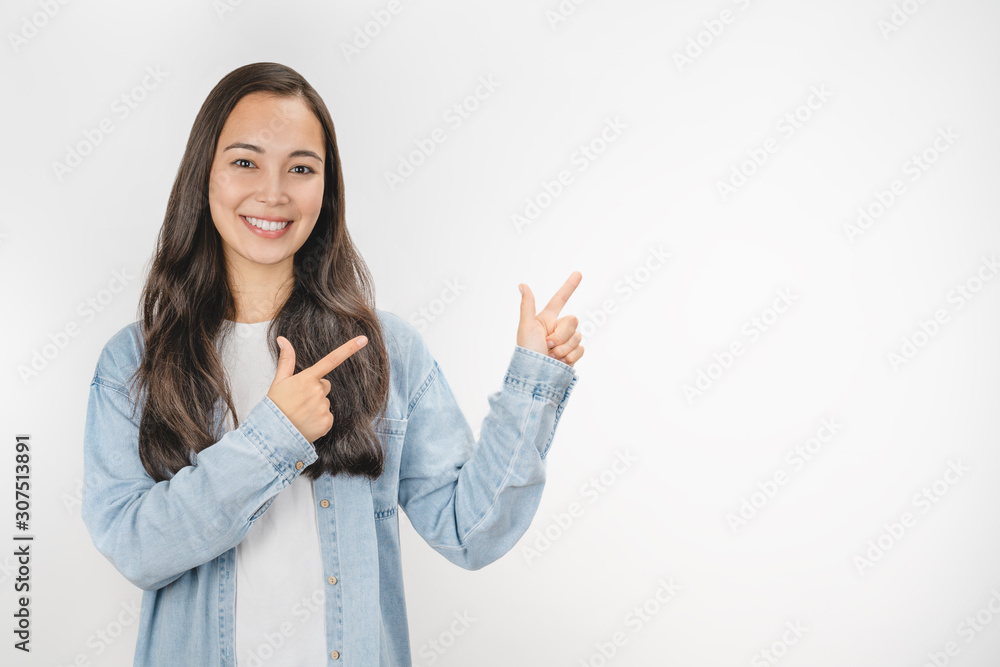 Image of happy young lady standing isolated over white background and pointing Image of happy young lady standing isolated over white background and pointing