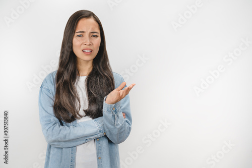 Young asian woman unhappy for not understand something over white isolated background