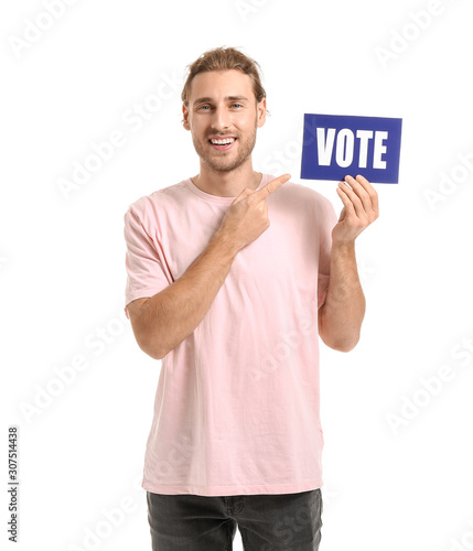 Young man holding paper with text VOTE on white background © Pixel-Shot