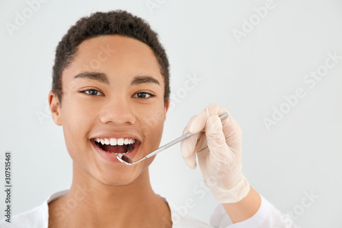 Dentist examining teeth of ...