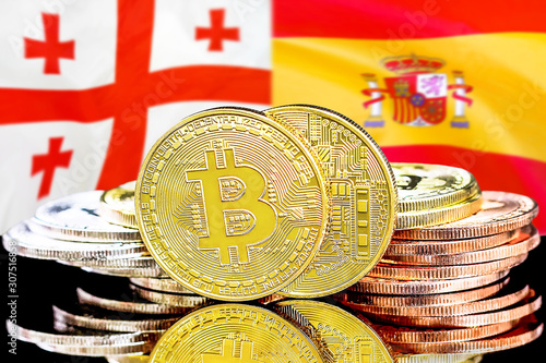 Concept for investors in cryptocurrency and Blockchain technology in the Georgia and Spain. Bitcoins on the background of the flag Georgia and Spain.