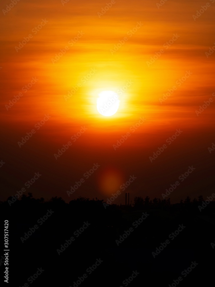 Beautiful sunset over sea. Tranquil scene of Closeup red sun and red sky sunset over the ocean