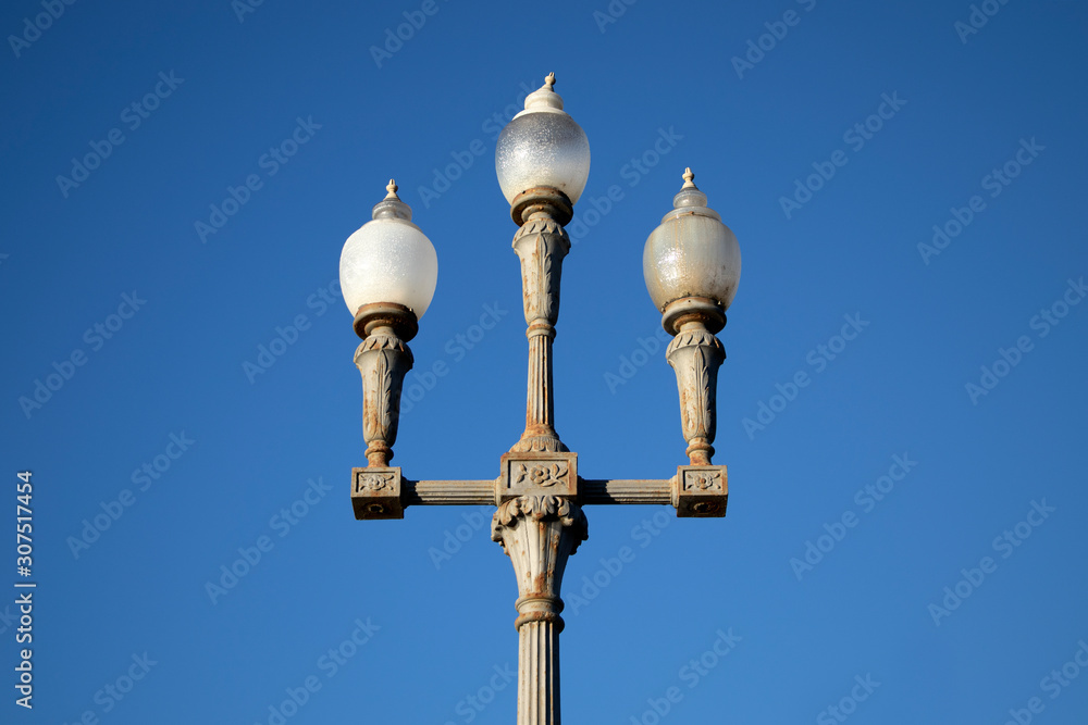 Old street lamp on background of blue sky