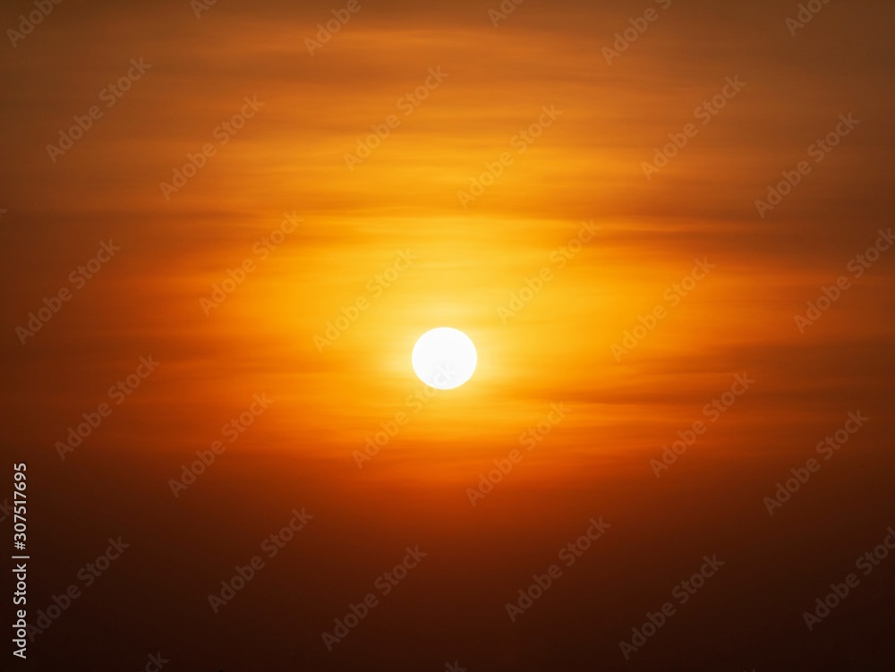 Beautiful sunset over sea. Tranquil scene of Closeup red sun and red sky sunset over the ocean